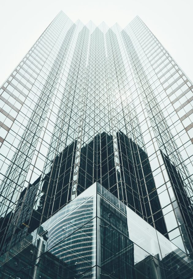 pexels-photo-1662159-1662159 Striking low angle view of a modern skyscraper with reflective glass facade in a cityscape.
